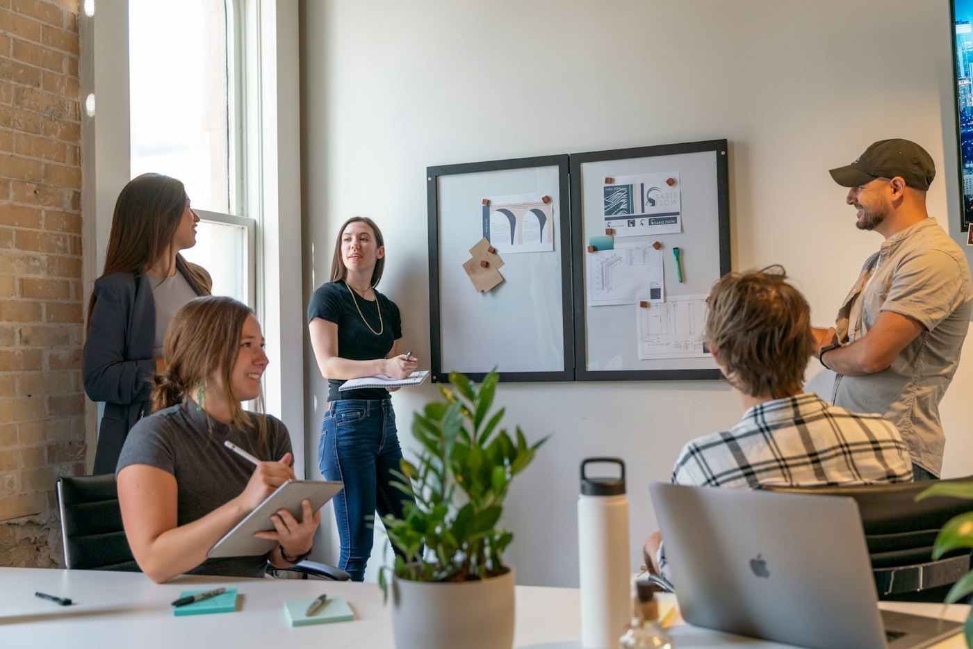A team collaborating around a table in a sunlit office.